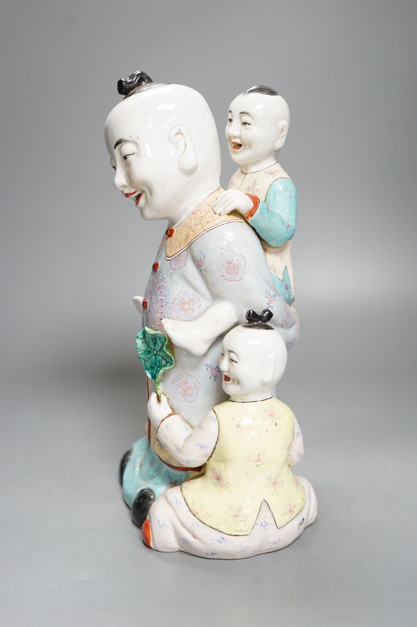 A large Chinese enamelled porcelain boys group, 31cm